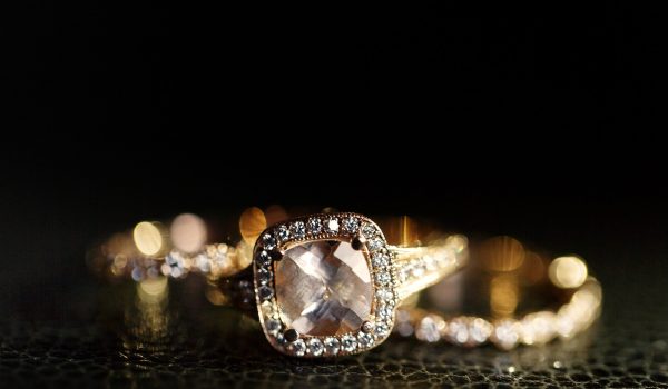 Jewels sparkle in the golden wedding rings lying on the leather